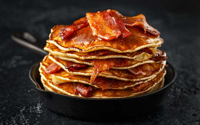Pancakes With Crispy Bacon And Maple Syrup In Cast Iron